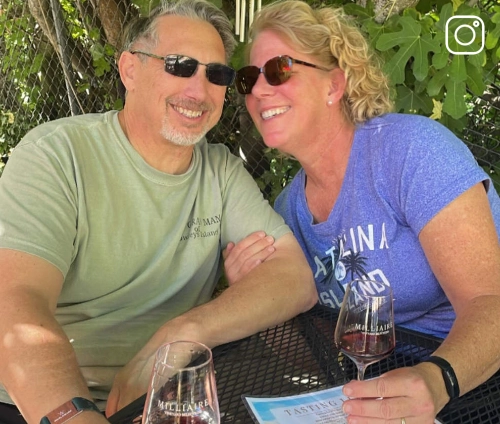 a couple enjoying a glass of Milliaire wine
